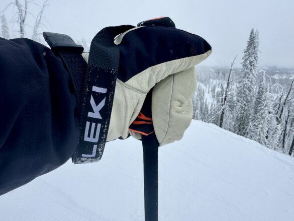 The author's hand gripped around the handle of the ski poles outside while skiing.