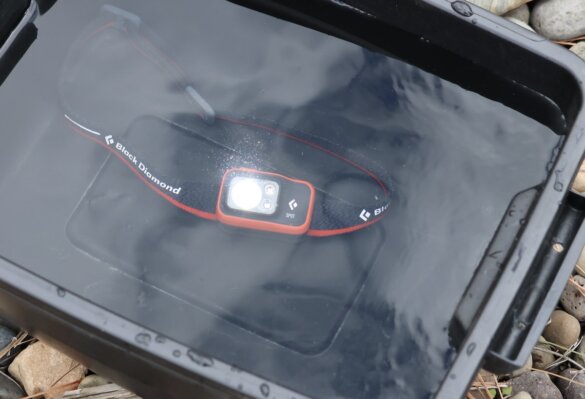 BD Spot 400 headlamp submerged underwater while the author tested its waterproof rating.