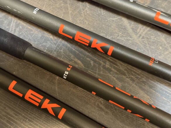 Closeup of four Leki Helicon Lite ski poles showing the aluminum uppers.