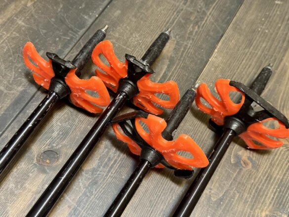 Closeup of the ski baskets on the end of two pairs of Helicon ski poles to show scuffing after use.