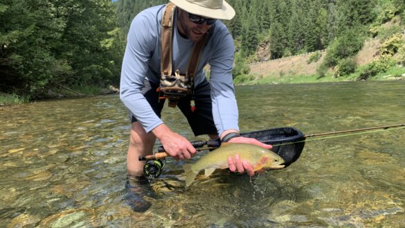 Author Chris Maxcer conducts in-water wading boot testing while fly fishing for trout.