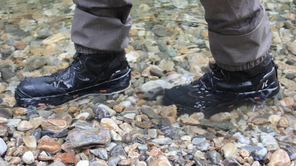 Author Chris Maxcer side-by-side tests different sole options on wading boots in the water.