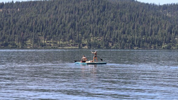 Teenagers play on the Retrospec Siesta Dock XL Inflatable Platform 10' out on a lake in Idaho.