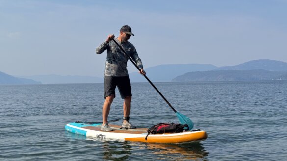 Author standup paddleboarding on the BOTE WULF Aero iSUP on a mountain lake in Idaho.