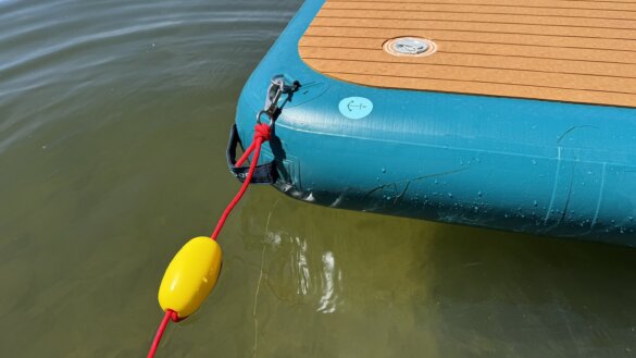 Anchor rope attached to D-ring on the Siesta Dock while it floats on a lake.