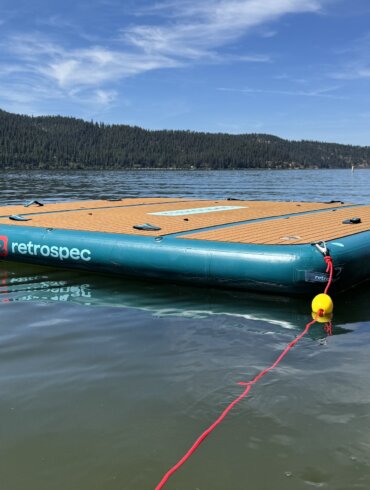 Retrospec Siesta Dock XL Inflatable Platform 10' floating on a mountain lake with an anchor rope attached.