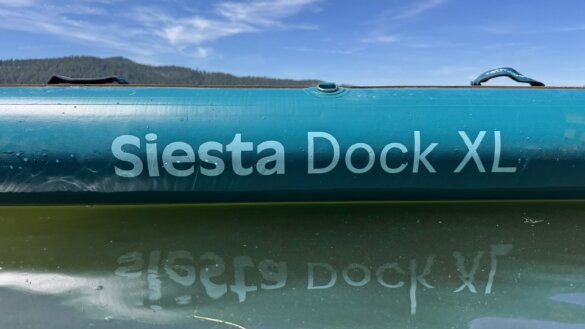 Side profile view of the Siesta Dock XL as it floats on a lake.