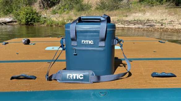RTIC Ultra-Tough Soft Cooler in Marine color option on top of a floating dock at a beach.