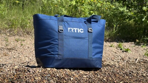 RTIC Everyday Insulated Tote Bag full of food on a gravely beach.