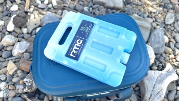 The RTIC reusable ice pack shown on top of the RTIC Ultra-Tough Soft Cooler.